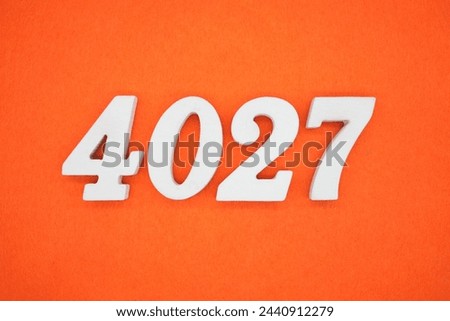 Orange felt is the background. The numbers 4027 are made from white painted wood.