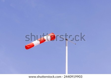 Photo of a wind sock with wind blowing through the sleeve on a clear blue sky sunny day taken in the town of Benidorm in Spain