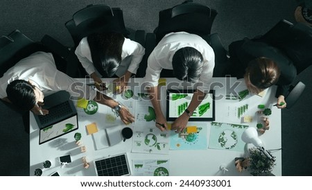 Top view of executive manager hold tablet display clean energy at meeting. Aerial view of business people working together to plan and invest in sustainable environmental investment. Alimentation. Royalty-Free Stock Photo #2440933001