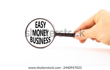 Easy money business symbol. Concept words Easy money business in beautiful magnifying glass. Beautiful white table white background. Businessman hand. Easy money business concept. Copy space.