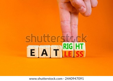 Eat less or right symbol. Concept words Eat less or Eat right on wooden cubes. Beautiful orange table orange background. Doctor hand. Healthy lifestyle and eat less or right concept. Copy space. Royalty-Free Stock Photo #2440947091