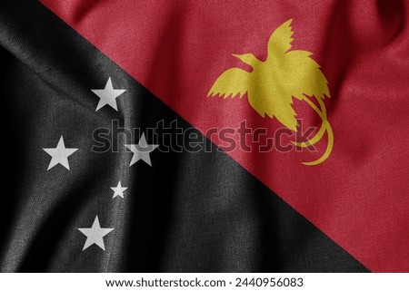 National Flag on Textured Fabric Background. Silk textured flag, realistic wave and flag look. PG  Flag of Papua New Guinea