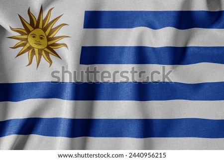 National Flag on Textured Fabric Background. Silk textured flag, realistic wave and flag look. UY  Flag of Uruguay