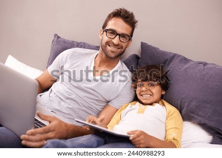 Portrait, father and child with laptop or tablet in bed for connectivity, technology and streaming online for news. Family, man and young boy at home with computer, movie or cartoon for bonding