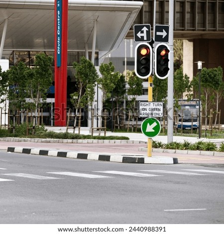 Road sign, traffic light and city with arrow for direction with travel information, typo or mistake for humor. Street, urban or metro buildings at bus stop, location and public transport in Cape Town Royalty-Free Stock Photo #2440988391