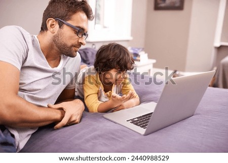 Family, father and son with laptop in bed for cartoon, movie and connectivity with technology for online streaming. People, man and child at home with computer or internet for bonding in house