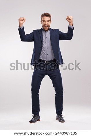 Excited, portrait or businessman with success and smile for winning a prize in studio on white background. Cheering, sales offer or happy salesman with motivation, news announcement or achievement Royalty-Free Stock Photo #2440989105