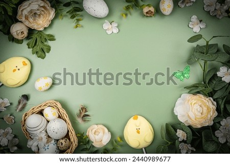 Happy Easter composition for easter design. Elegant Easter eggs with flowers on pastel green background. Flat lay, top view, copy space.