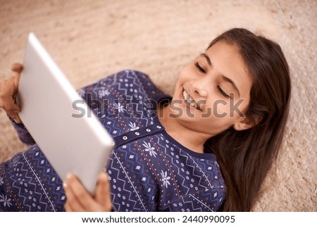 Floor, smile or child with tablet for streaming, playing games or watching fun videos on movie website. Above, house or happy kid with technology to download online or fun social media app to relax