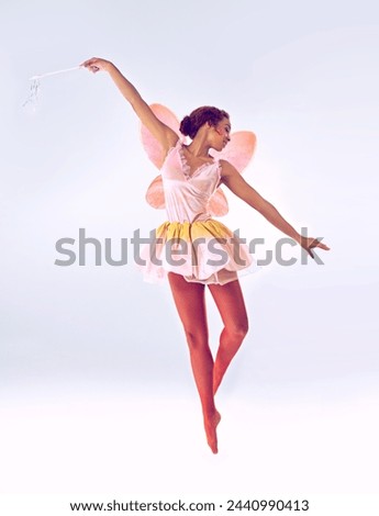Woman, fairy and ballerina for dancing in studio for fantasy, flight and moving by white background. Person, dancer and girl with magic, costume and butterfly wings for ballet, art and creativity