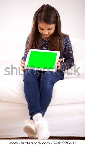 Home, green screen or child with tablet for mockup, playing games or streaming videos on movie website. Space, online or female kid with ebook or technology to download on social media app on sofa