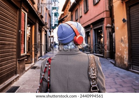 Young woman with platinum blonde hair enjoying the city beat. The vibrant urban life sets a perfect stage for her stylish exploration.Vibrant urban chic. Royalty-Free Stock Photo #2440994561