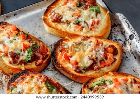 Close-Up 4K Ultra HD Image of Bruschettas with Meat, Chili Beans, and Cheese - Stock Photography