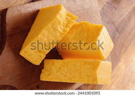 Close-Up 4K Ultra HD Image of Block of Cheese - Stock Photography