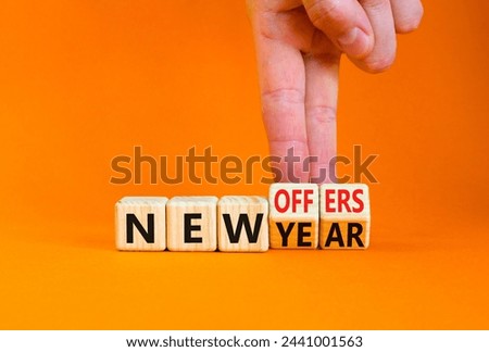New year and offers symbol. Concept word New year New offers on beautiful wooden cubes. Beautiful orange table orange background. Businessman hand. Business new year and offers concept. Copy space.