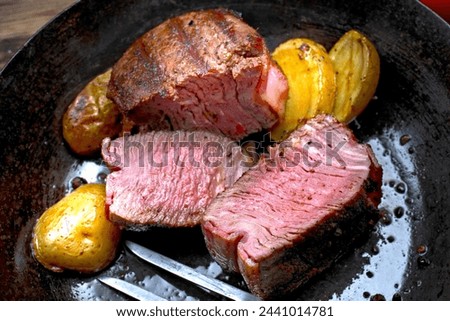 Close-Up 4K Ultra HD Image of Grilled Juicy Sirloin Steak with Potatoes - Stock Photography
