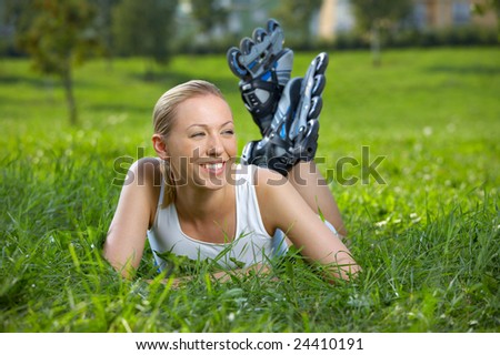 The smiling blonde in rollers lies on a lawn