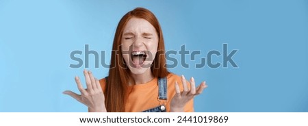 Lifestyle. Pissed outraged moody redhead girl shouting complaining angry standing bothered screaming out loud close eyes yelling loudly raising hands sideways dismay full disbelief feel cheated Royalty-Free Stock Photo #2441019869
