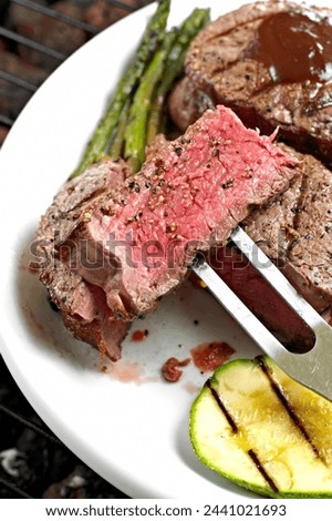 Close-Up 4K Ultra HD Image of Grilled Juicy Sirloin Steak with Potatoes in plate - Stock Photography