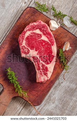 Close-Up 4K Ultra HD Image of Raw Ribeye Steak with Herbs - Stock Photography