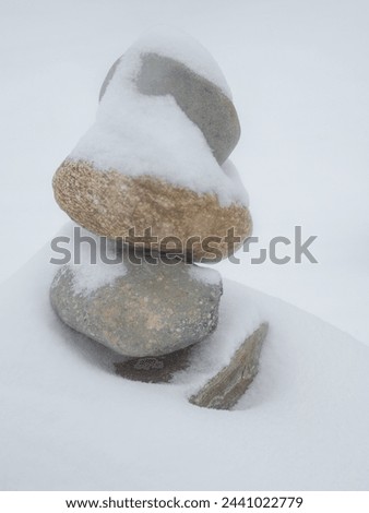 Snow on stones stacked in winter