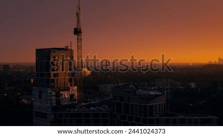 Beautiful Evening City Skyline with Purple and Orange Hazy Horizon and Buildings in the Foreground  Royalty-Free Stock Photo #2441024373