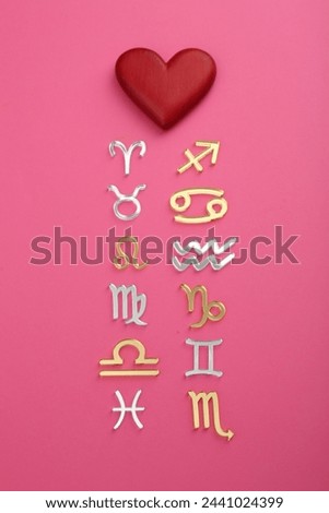 Zodiac compatibility. Signs with red heart on pink background, flat lay Royalty-Free Stock Photo #2441024399