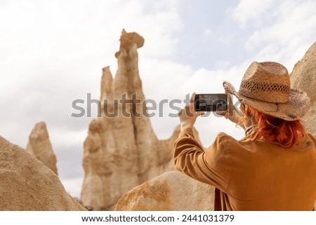 Woman taking selfie, smiling, call us on phone, Woman with hat in nature brown clothes, adventures orgues