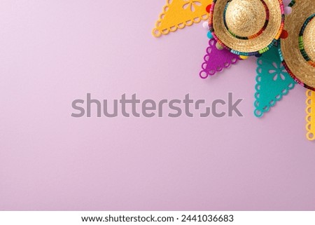 Cinco de Mayo essence. Top-down view capturing festive elements: sombreros, flag decor, arranged on a pastel purple surface, with space for words Royalty-Free Stock Photo #2441036683