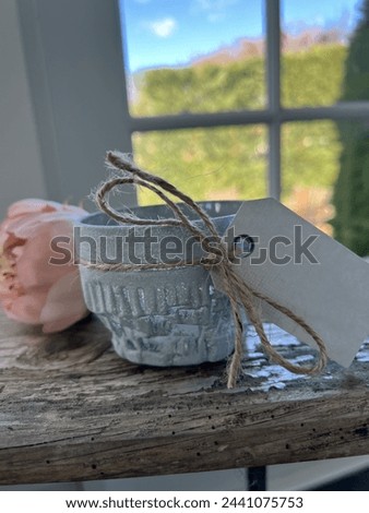 Tea light holder in light blue with twine and tag and peony