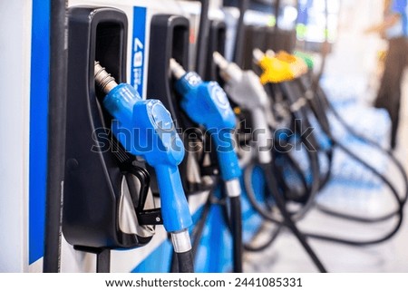 Selective focus to gas pump nozzles in a service station, Close up fuel nozzles at gas station, Panel and Dashboard of fuel nozzles of E85 E20 and Gasohol 91. The concept of fuel energy. Royalty-Free Stock Photo #2441085331