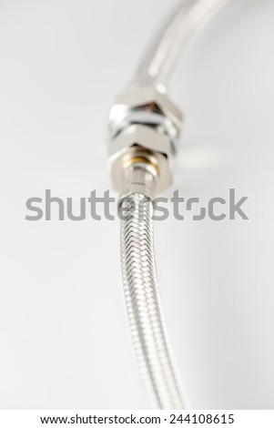 industrial elastic metal fiber water pipe with connectors on white background