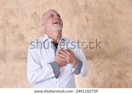 portrait of charming man in black and white shirt with gray beard and bald head feeling pain madel