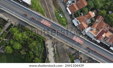 City road with train crossing bridge
City streets seen from above using a drone in the afternoon