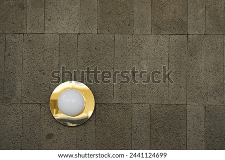 Glow: Elegant White Wall Lamp Adorning Grey Wall in Afternoon Ambiance