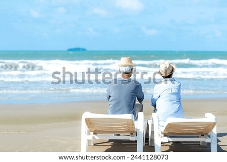 Asian Lifestyle senior couple hug and sitting on the beach happy in love romantic and relax time.  People tourism elderly family travel leisure and activity after retirement in vacations and summer Royalty-Free Stock Photo #2441128073
