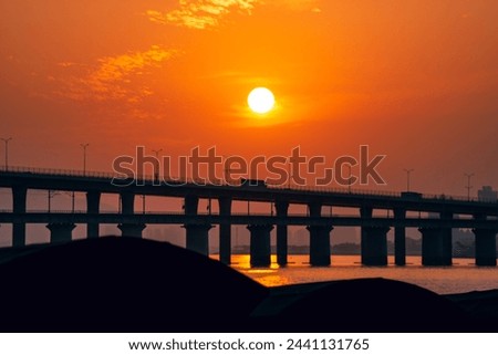 Sunset moment near seaside with elevated railway track, beach, sea