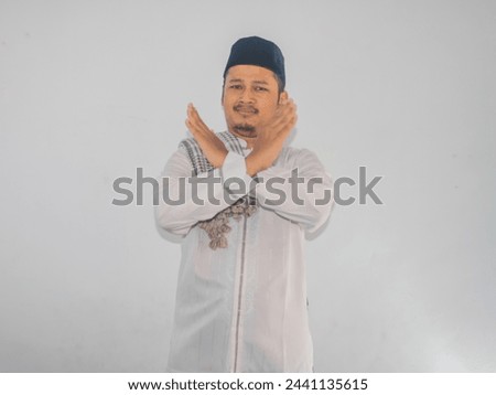 Adult Asian man showing angry expression while making stop hand sign