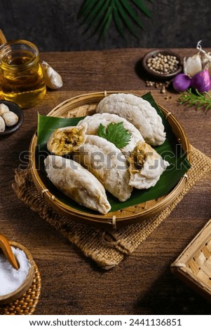 Fried cireng filled with shredded chicken in a woven bamboo plate Royalty-Free Stock Photo #2441136851
