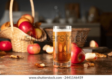 Apple cider with apples on an old kitchen table.