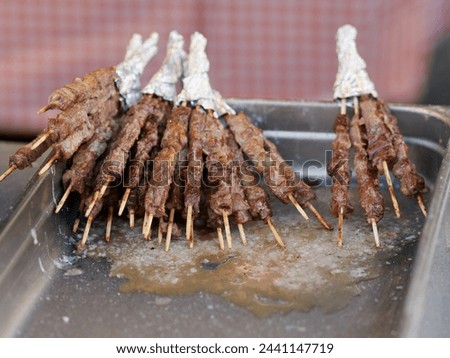A typical central Italy dish: lamb "arrosticini". They are thin skewers of mutton cooked on the grill Royalty-Free Stock Photo #2441147719