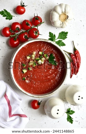 Gazpacho - traditional spanish cold  soup with cucumber and garlic on a white slate, stone or concrete background. Top view with copy space. Royalty-Free Stock Photo #2441148865