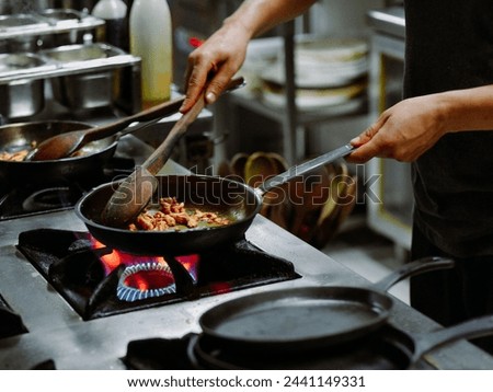 a picture of a chef cooling using a pan
