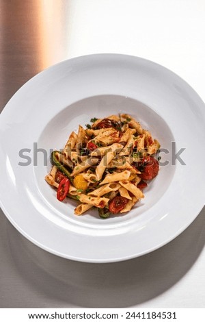 Close-Up of Penne Pasta Served in Plate in 4K Ultra HD Resolution - Stock Photography
