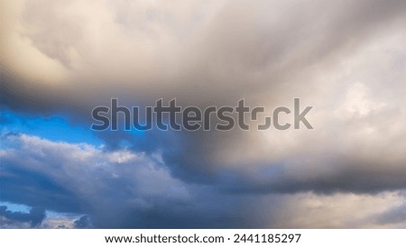 Clouds in the sky during a storm. Huge clouds as a background. Natural phenomenon. Picture for background or wallpaper.