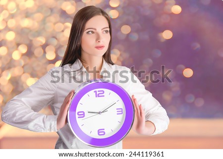 Beautiful  woman holding big clock.  girl holding big clock. Young businesswoman with  keeps watch