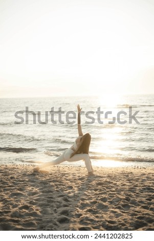 yoga, woman doing yoga, girl, sport, pose, arms, asana, sports, action, energy, beach. Royalty-Free Stock Photo #2441202825