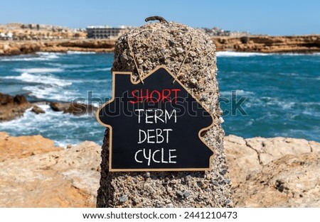 Short term debt cycle symbol. Concept words Short term debt cycle on beautiful black chalk blackboard. Beautiful stone blue sea sky background. Business Short term debt cycle concept. Copy space