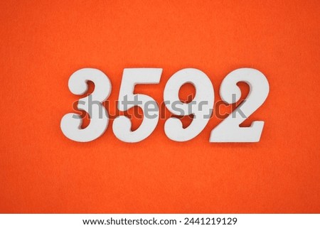 Orange felt is the background. The numbers 3592 are made from white painted wood.