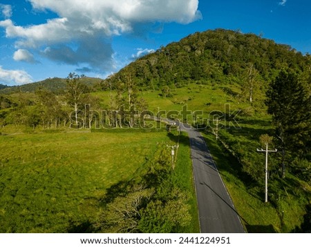 Country road through green fields , looking straight down, Chiriqui, Panama, - stock photo